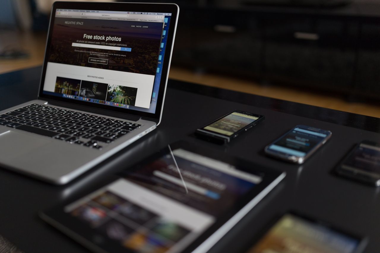 A modern work setting with a laptop, tablet, and smartphones, well suited to technology and freelance work.