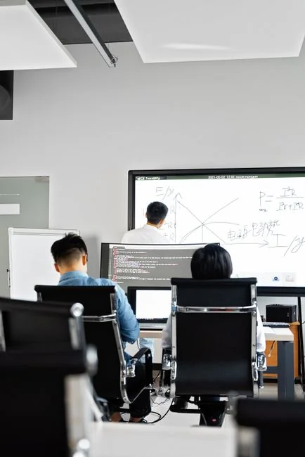 A contemporary workspace with two computer monitors showing web design projects, highlighting technology and productivity.